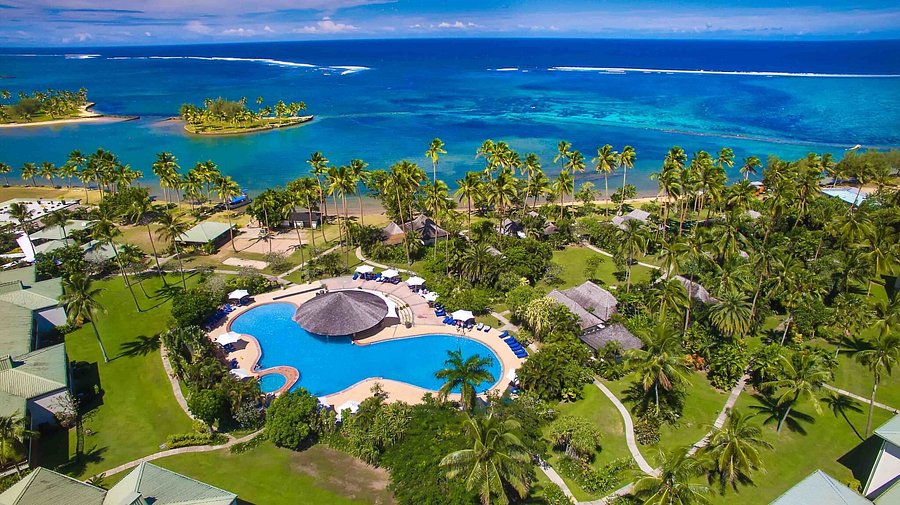 Aerial view of The Naviti Resort pool, palm-lined grounds and turquoise lagoon
